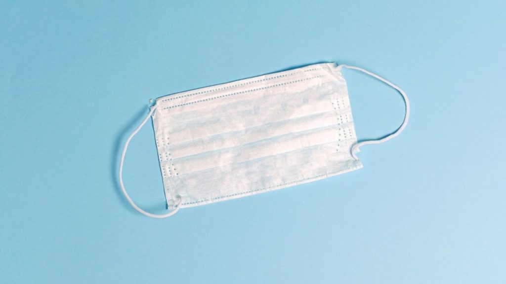 disposible face mask on a blue background