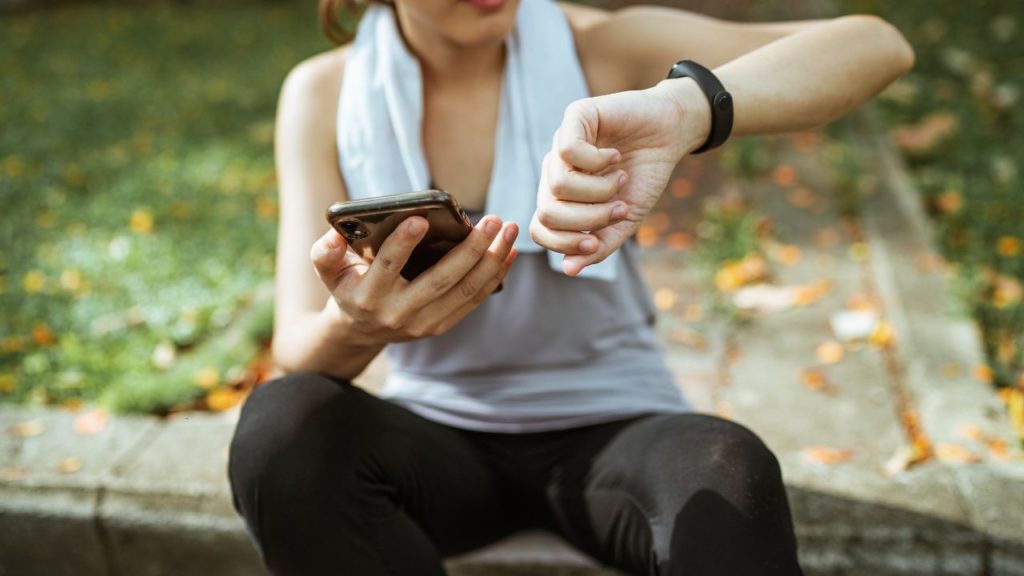 woman exercising with app and fitness tracker watch